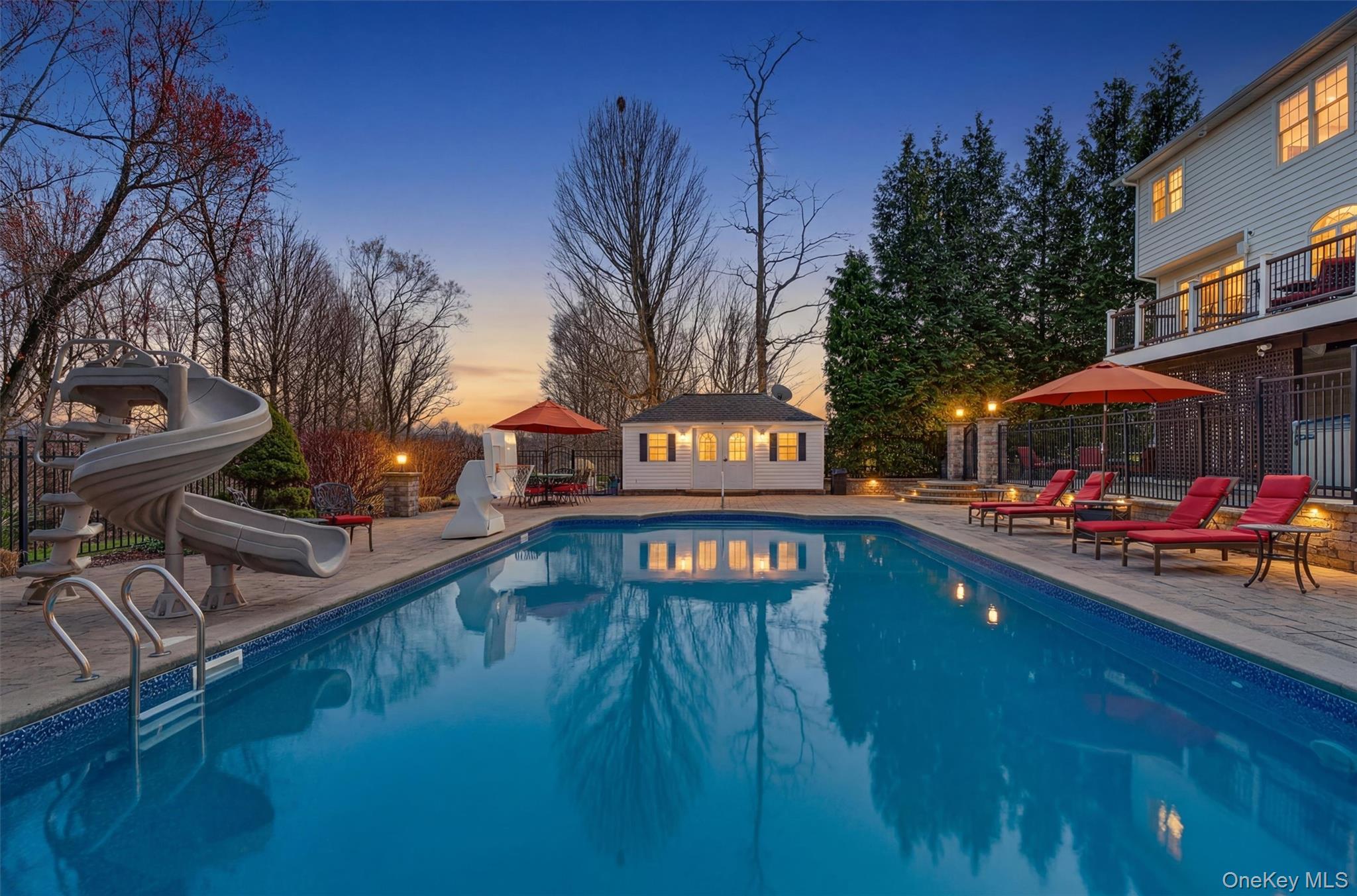 196 Country Club Road Hopewell Junction, NY 12533 - Photo 39 of 50 Step into your own private resort, where luxury, comfort, and unforgettable entertaining come together in one spectacular outdoor setting. This stunning 22' x 48' in-ground swimming pool is the centerpiece of the backyard oasis, complete with a heater, new pump, new salt cell, and new filter—ensuring effortless enjoyment all season long, while a full automation package allows you to control pool features right from your iOS device for ultimate convenience. Surrounding the pool, an expansive patio offers the perfect layout for entertaining, lounging, and dining, complemented by a beautifully designed 12' x 20' pool house fully hardwired for electric and audio. Whether hosting summer gatherings or enjoying quiet evenings under the stars, the ambiance is elevated by a fully integrated outdoor sound system with 10 wired speakers strategically placed throughout, including pool rock, pool house, deck, under-deck, and fire pit areas, creating a truly immersive experience. With its seamless blend of high-end upgrades