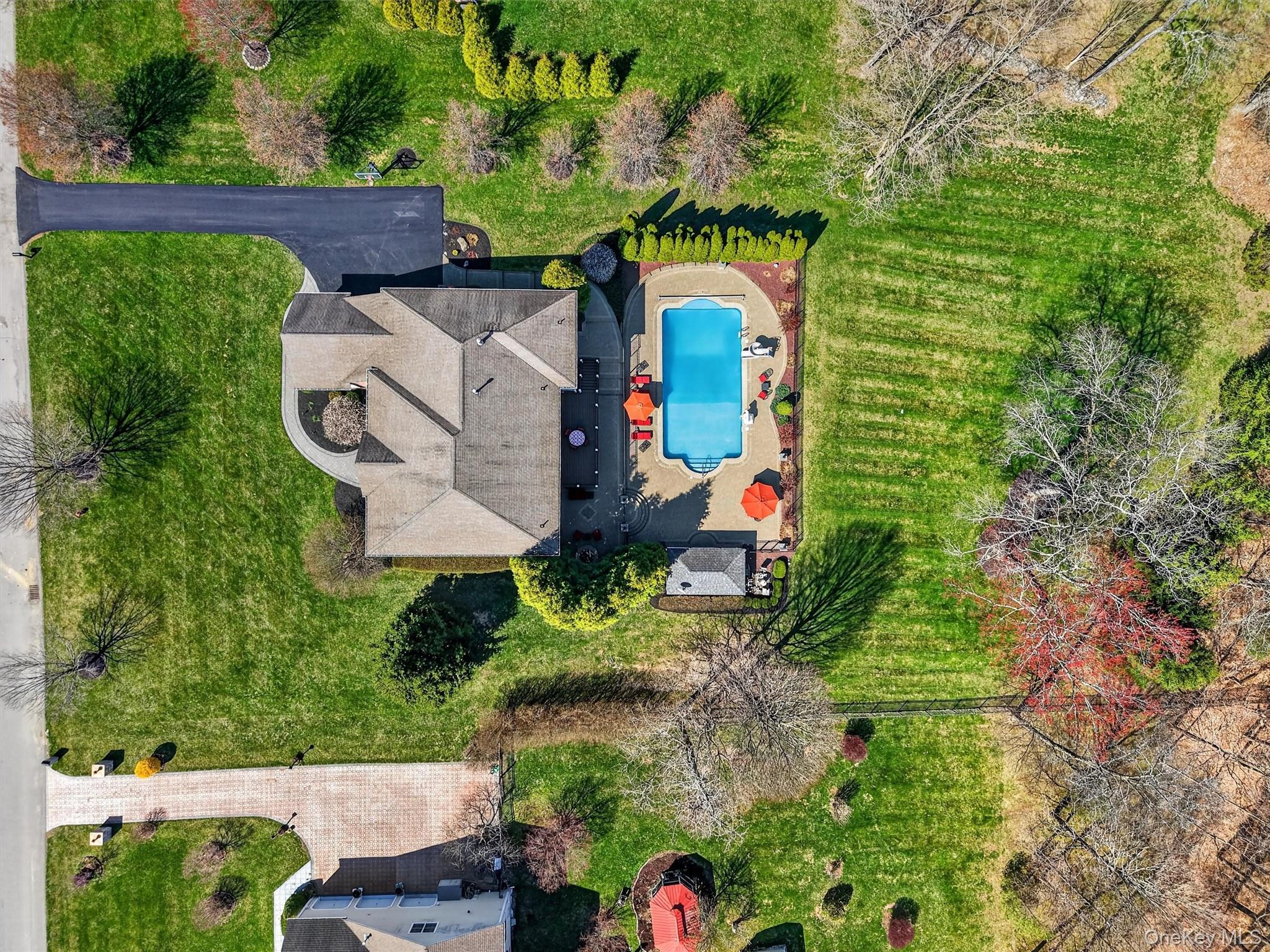 196 Country Club Road Hopewell Junction, NY 12533 - Photo 46 of 50 The expansive, level front yard is the epitome of classic Americana, featuring professionally manicured lawns that stretch gracefully across the property. Framed by mature trees that provide both privacy and natural beauty, the tree-lined setting creates a serene, park-like atmosphere and timeless curb appeal. This picturesque setting is further enhanced by numerous recent upgrades, including a new furnace, replaced and upgraded AC condenser units and coils, freshly washed windows, a professionally power-washed exterior, a newly paved driveway, and new garage doors. The result is a home that perfectly captures refined suburban elegance while offering peace of mind with its meticulous maintenance and improvements.