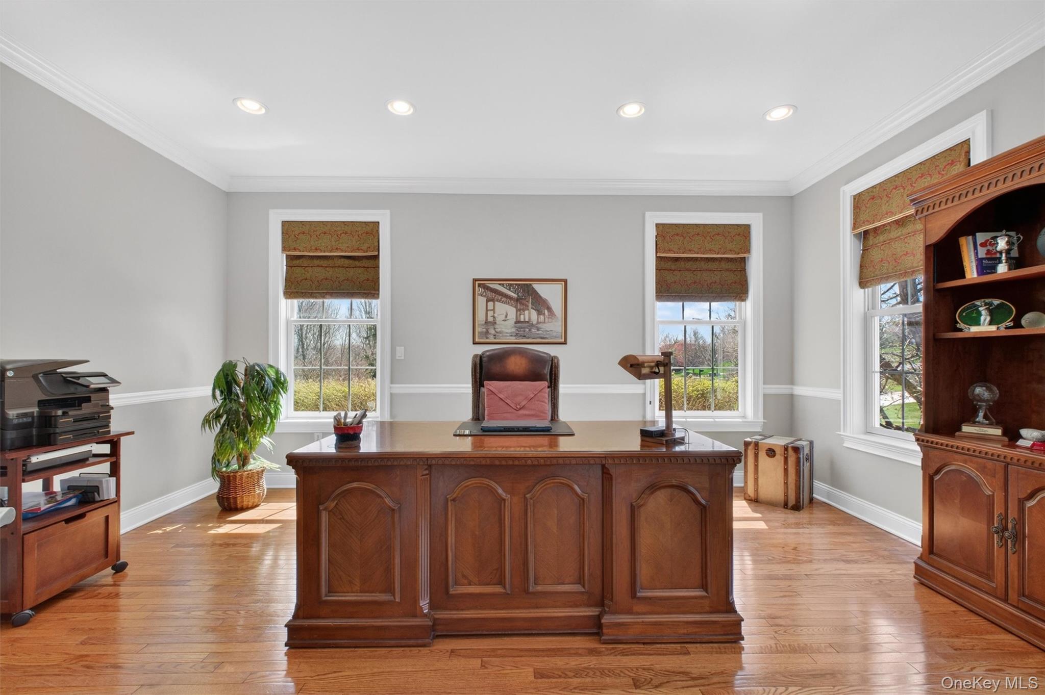 196 Country Club Road Hopewell Junction, NY 12533 - Photo 6 of 50 Step into this commanding executive office, an expansive and versatile space designed to meet the highest standards of both professionalism and comfort. Impressive in scale, the room easily accommodates a full seating area—including a couch—creating a refined environment ideal for meetings, work, or quiet retreat. Gleaming hardwood floors carry through from the main level, while soaring ceilings, recessed lighting, and an abundance of oversized windows bathe the space in natural light, enhanced by elegant custom fabric shades. Grand in size and thoughtfully designed, this remarkable room offers incredible flexibility and could easily be transformed into a luxurious first-floor primary suite, making it as practical as it is sophisticated