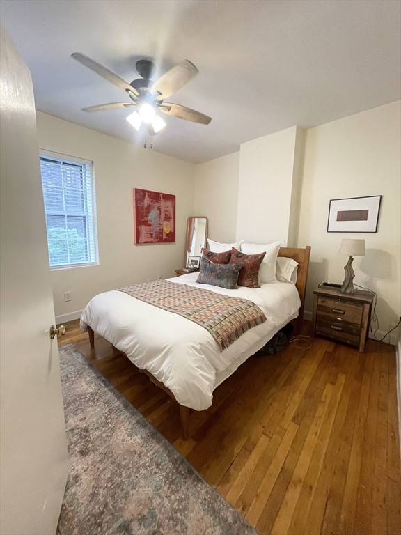 9 Primus Avenue, Unit 1 Boston, MA 02114 - Photo 15 of 19 a bedroom with a bed and wooden floor