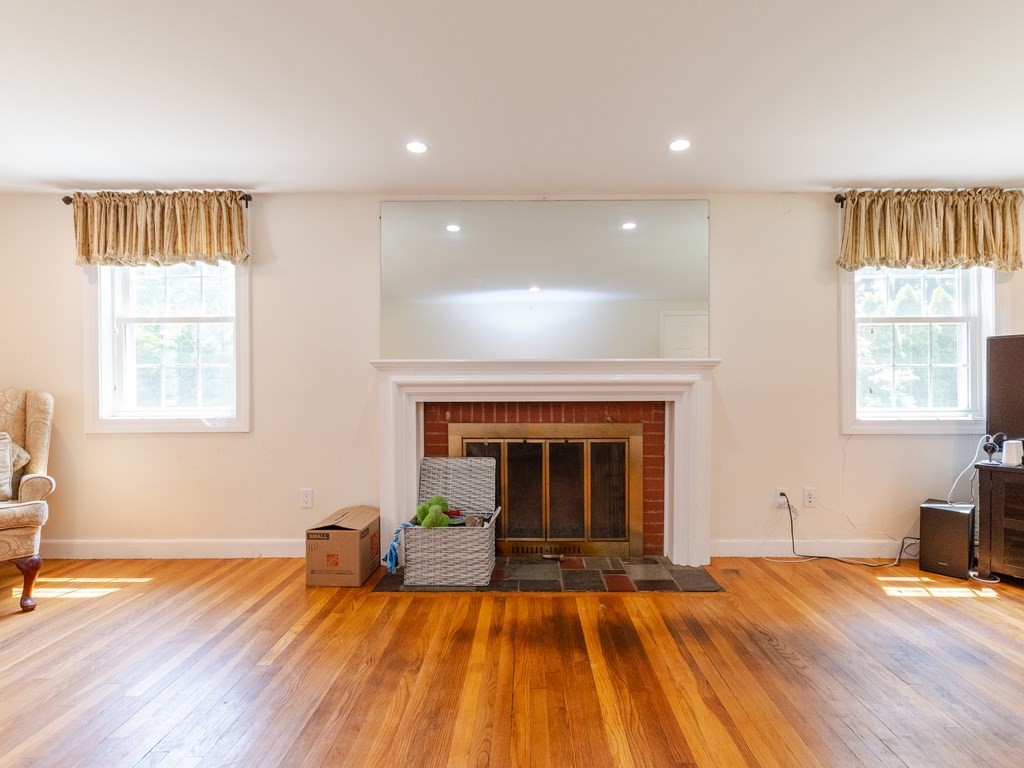 95 Blake Street Newton, MA 02460 - Photo 13 of 22 a view of empty room with wooden floor and fireplace