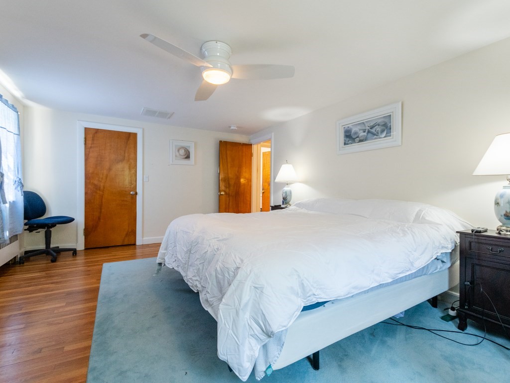 95 Blake Street Newton, MA 02460 - Photo 17 of 22 a spacious bedroom with a bed and table chair