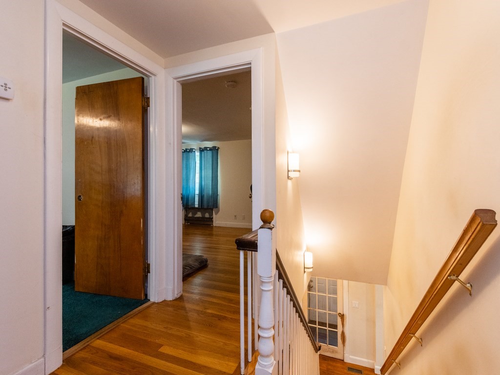 95 Blake Street Newton, MA 02460 - Photo 21 of 22 a view of a hallway with wooden floor and stairs