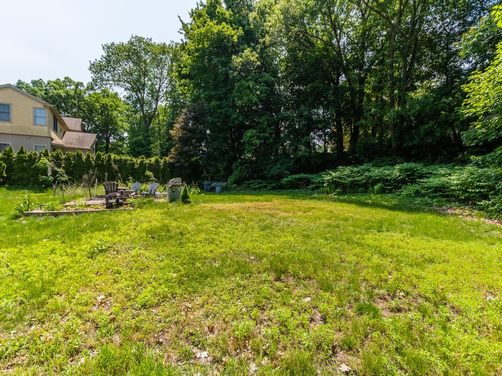 95 Blake Street Newton, MA 02460 - Photo 3 of 22 a view of a swimming pool with a big yard and large trees