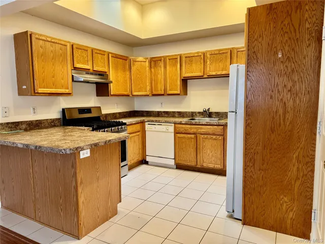 a kitchen with a stove top oven sink and cabinets