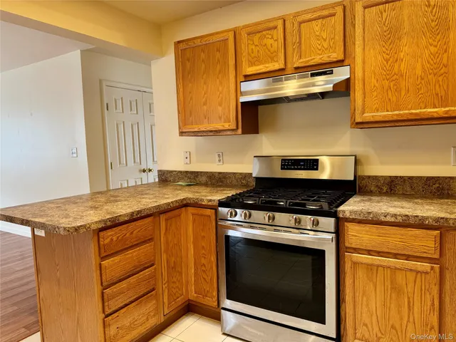 a kitchen with granite countertop stainless steel appliances and cabinets