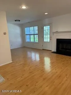 an empty room with a fireplace and windows