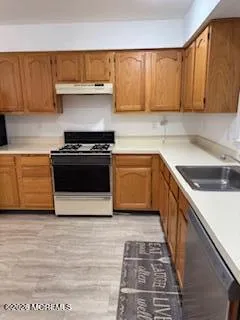 a kitchen with stainless steel appliances a refrigerator and a stove