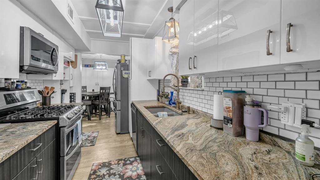 5808 Bunker Boulevard Watauga, TX 76148 - Photo 17 of 36 a kitchen with sink stove and cabinets