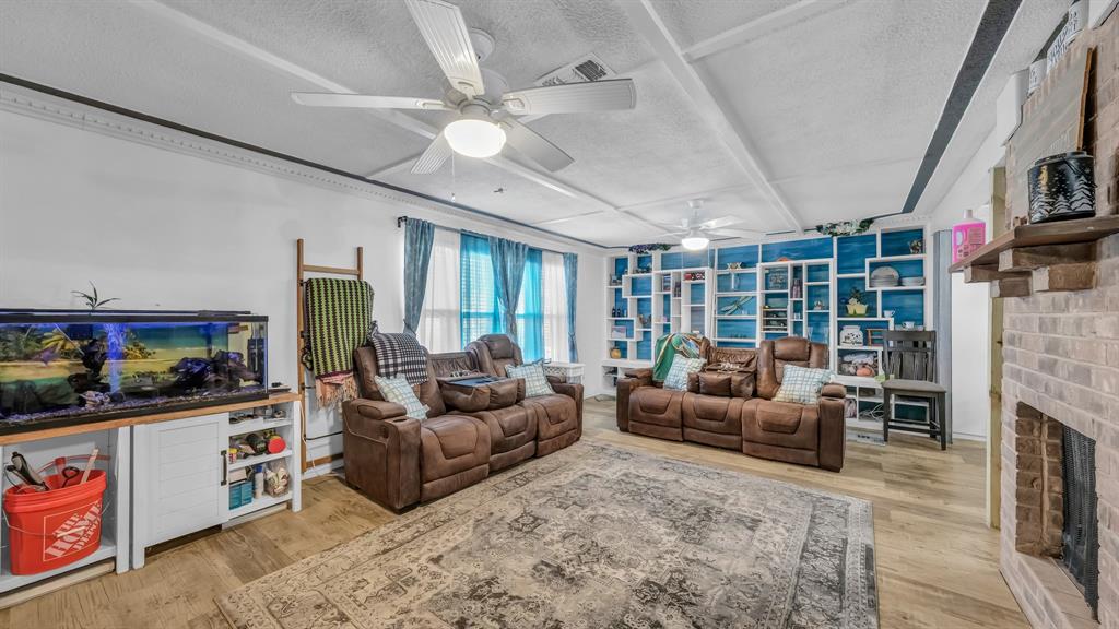 5808 Bunker Boulevard Watauga, TX 76148 - Photo 8 of 36 a living room with fireplace furniture and a flat screen tv