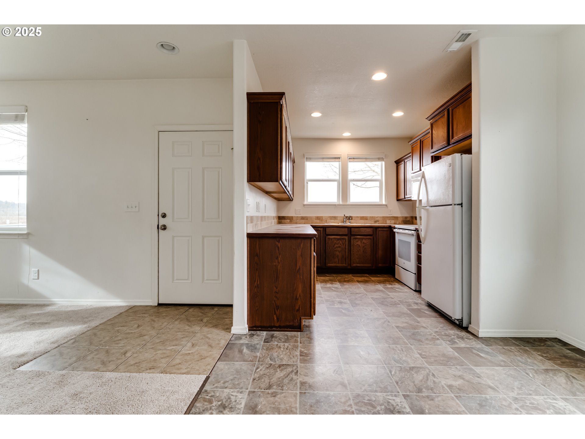 1565 Legacy Street Eugene, OR 97402 - Photo 9 of 27 a kitchen with granite countertop a refrigerator and a sink