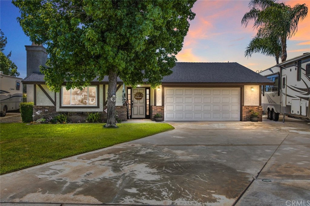 a front view of a house with a yard and a garage