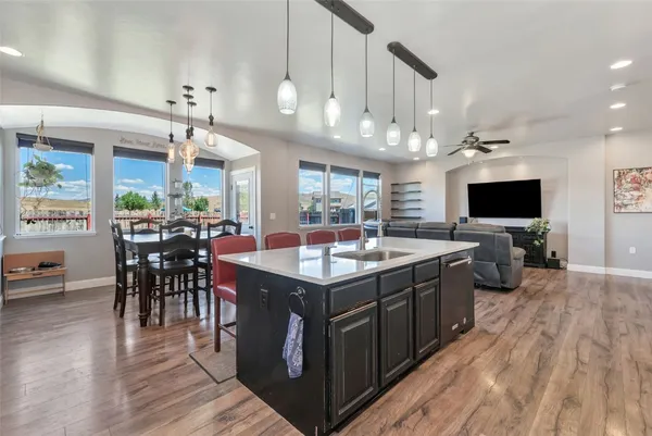 a kitchen with a stove and a wooden floor