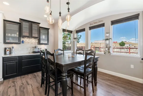 a view of a dining room with furniture window and wooden floor