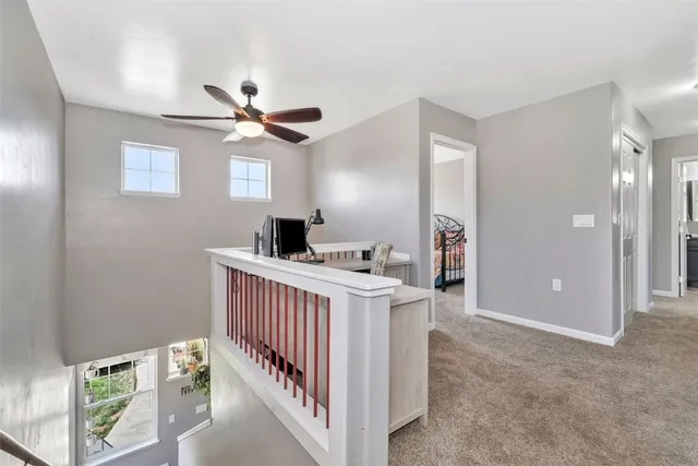 a view of a hallway to a livingroom with furniture