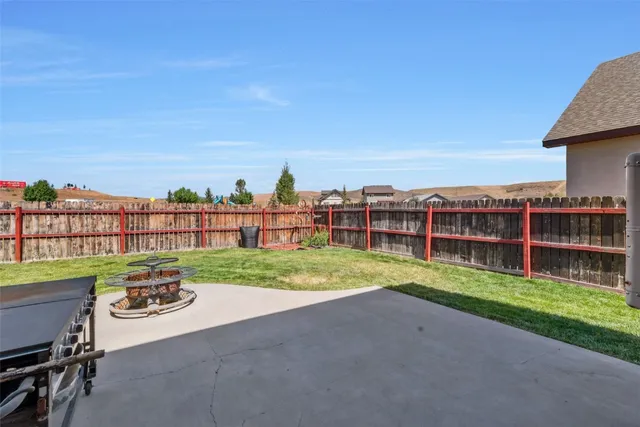 a view of a terrace with lawn chairs