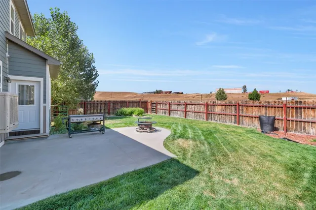 a view of a backyard with sitting area