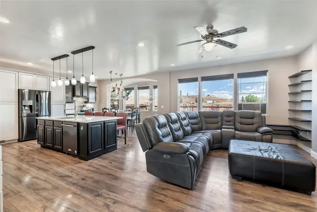 a living room with furniture kitchen and a chandelier