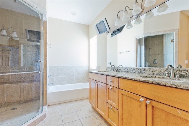 2828 South Lock Street Chicago, IL 60608 - Photo 12 of 21 a bathroom with a granite countertop sink mirror and a bathtub