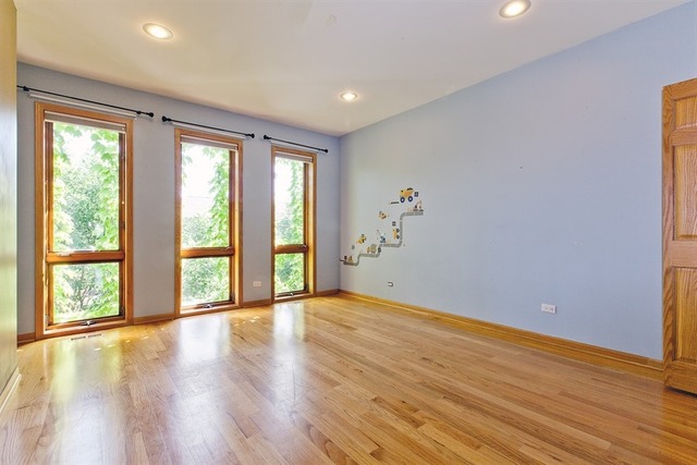 2828 South Lock Street Chicago, IL 60608 - Photo 14 of 21 a view of an empty room with wooden floor and a window