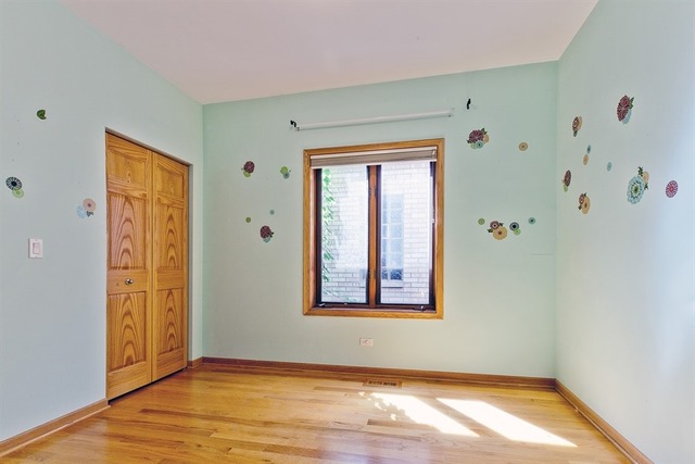 2828 South Lock Street Chicago, IL 60608 - Photo 16 of 21 a view of an empty room with window and wooden floor