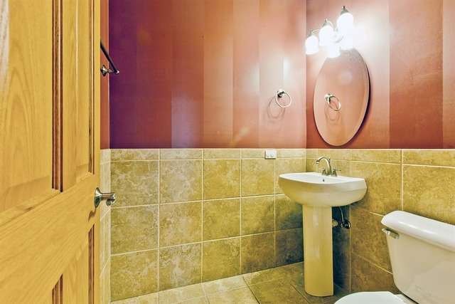 2828 South Lock Street Chicago, IL 60608 - Photo 18 of 21 a bathroom with a sink mirror and toilet