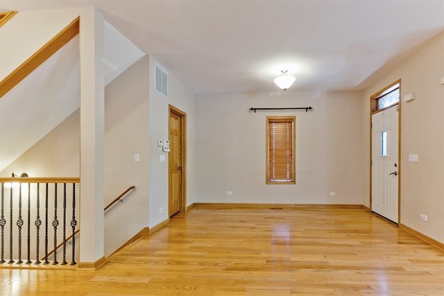 2828 South Lock Street Chicago, IL 60608 - Photo 2 of 21 a view of an empty room with wooden floor and a window