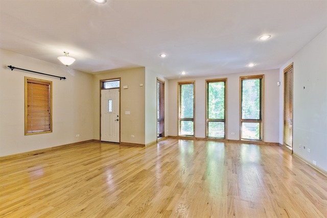 2828 South Lock Street Chicago, IL 60608 - Photo 3 of 21 a view of an empty room with wooden floor and a window