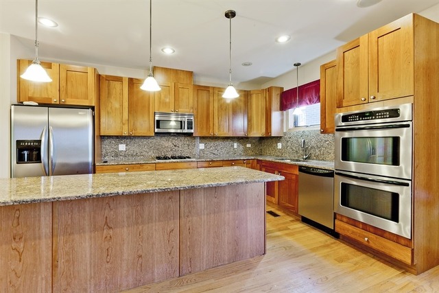2828 South Lock Street Chicago, IL 60608 - Photo 4 of 21 a kitchen with stainless steel appliances granite countertop a sink a stove and a refrigerator