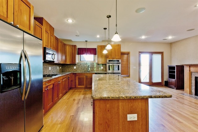 2828 South Lock Street Chicago, IL 60608 - Photo 5 of 21 a kitchen with stainless steel appliances granite countertop a sink a stove and a wooden floors