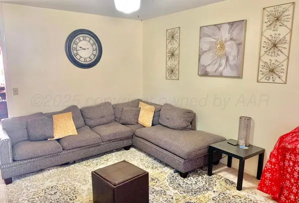 a living room with furniture and a rug