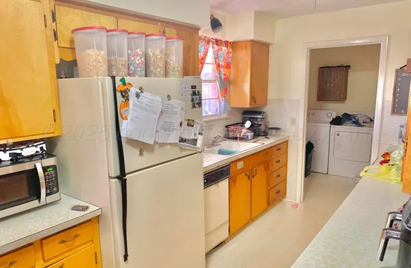 a kitchen with stainless steel appliances a stove a sink and a refrigerator