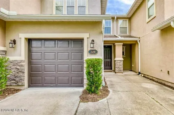 a front view of a house with a garage