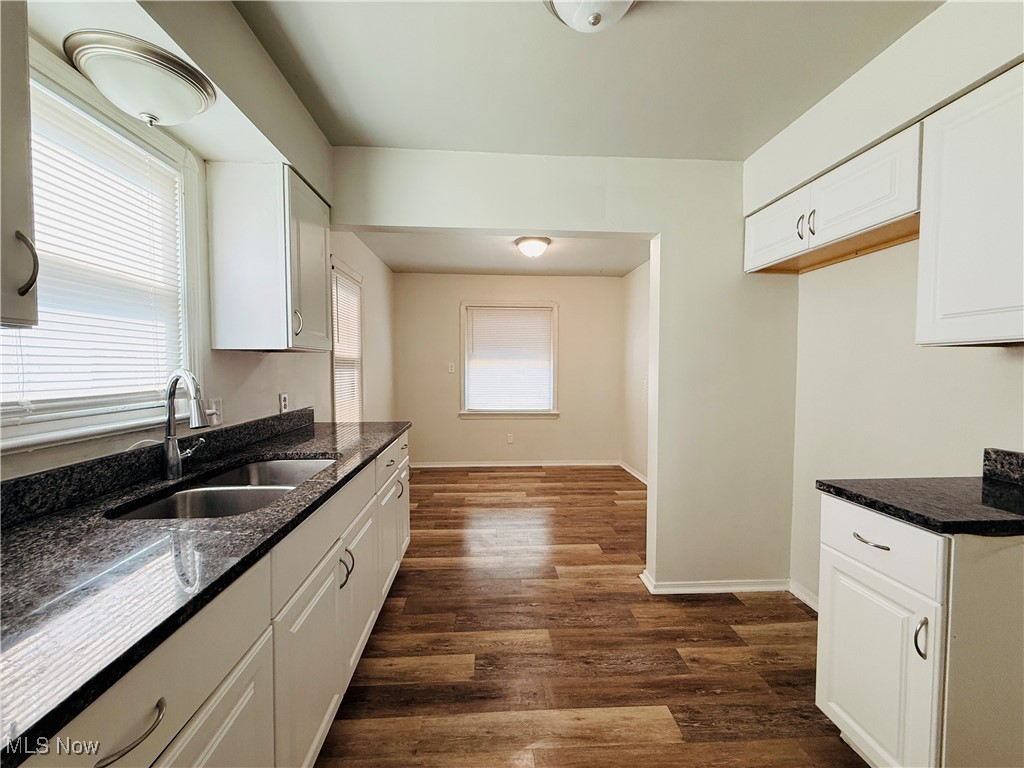 5239 Arch Street Maple Heights, OH 44137 - Photo 2 of 25 Kitchen with dark wood-type flooring, dark stone counters, and white cabinets