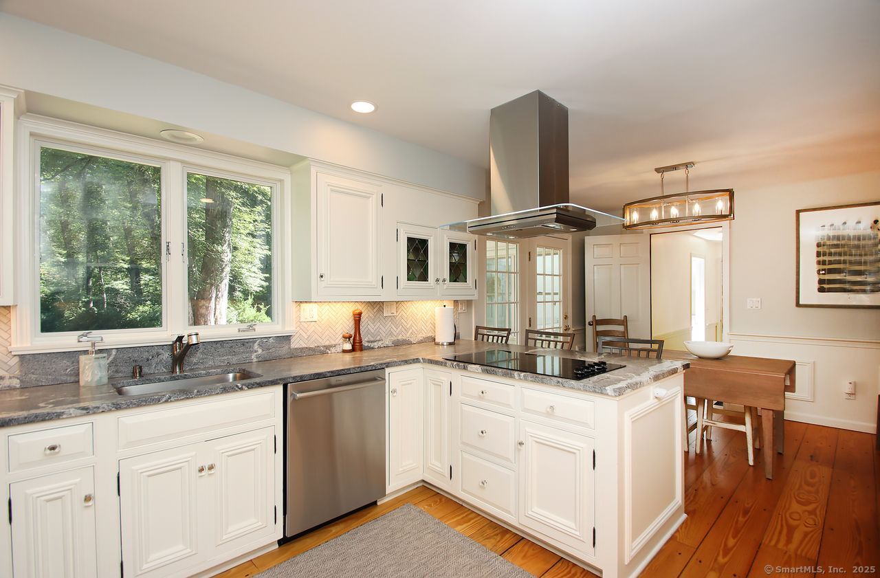 125 Wildcat Road Madison, CT 06443 - Photo 14 of 34 a kitchen with a sink stove and cabinets
