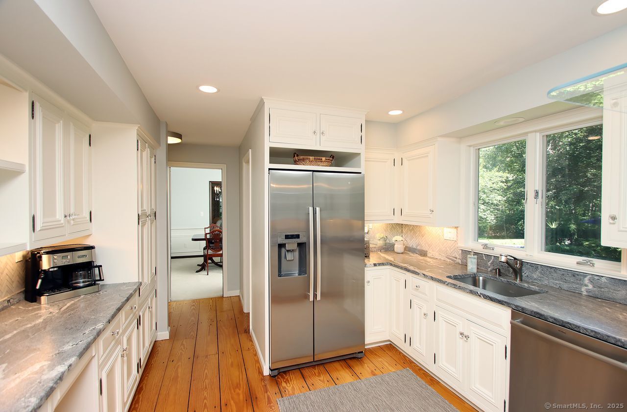 125 Wildcat Road Madison, CT 06443 - Photo 15 of 34 a kitchen with stainless steel appliances granite countertop a refrigerator and a sink