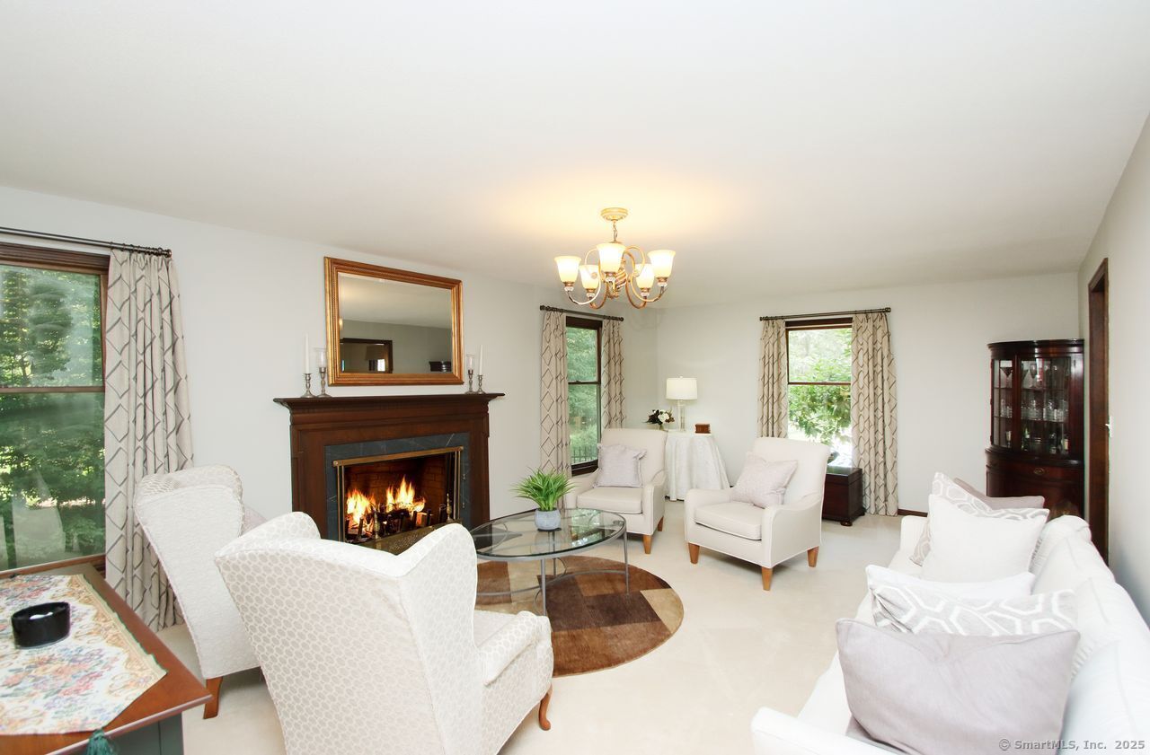 125 Wildcat Road Madison, CT 06443 - Photo 17 of 34 a living room with furniture and a fireplace