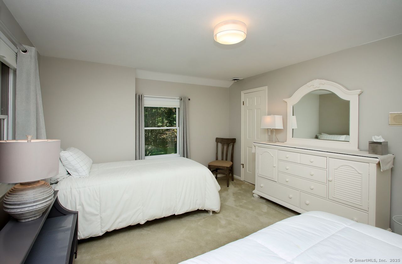125 Wildcat Road Madison, CT 06443 - Photo 20 of 34 a bedroom with a bed and a dresser