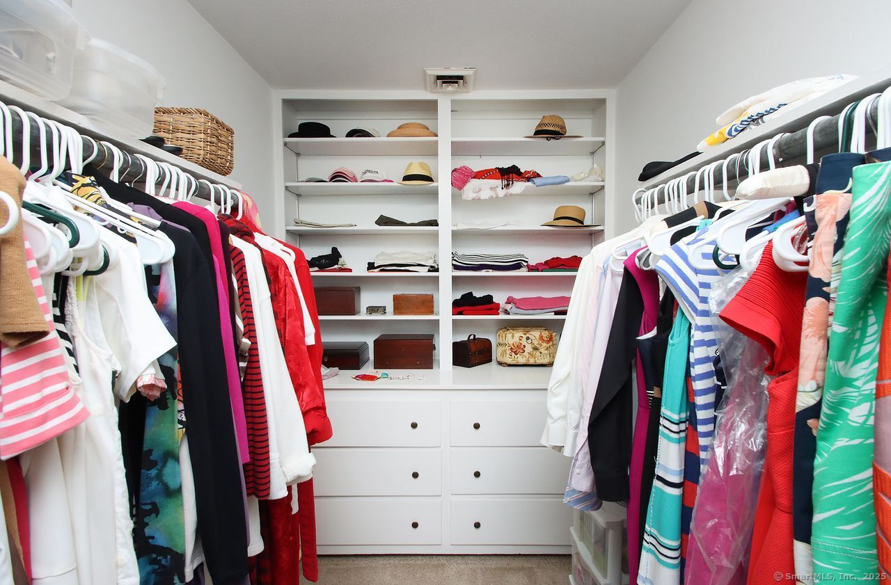 125 Wildcat Road Madison, CT 06443 - Photo 21 of 34 a view of walk in closet with clothes and shoes