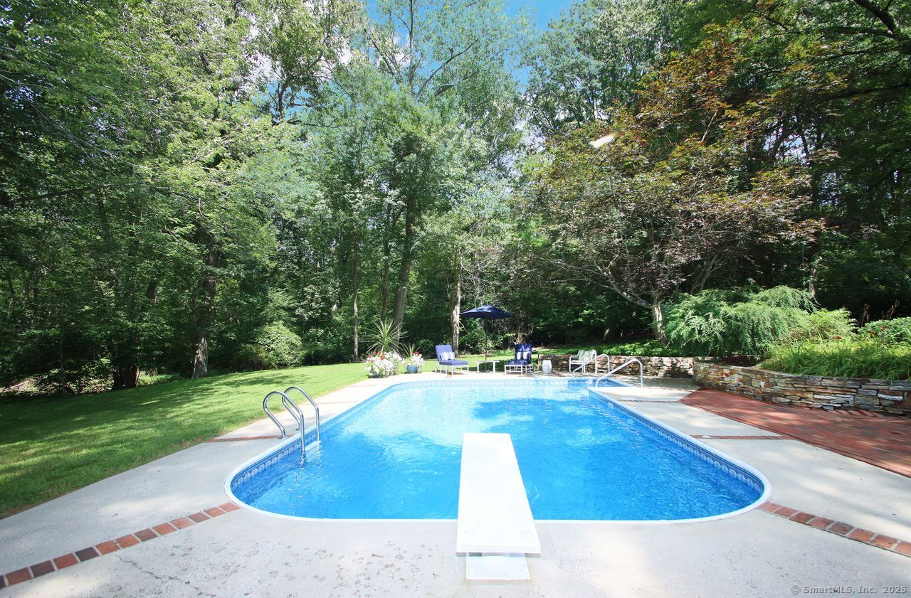 125 Wildcat Road Madison, CT 06443 - Photo 25 of 34 a swimming pool with trees in the background