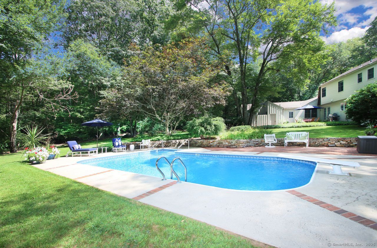 125 Wildcat Road Madison, CT 06443 - Photo 27 of 34 a view of pool with lawn chairs and large trees