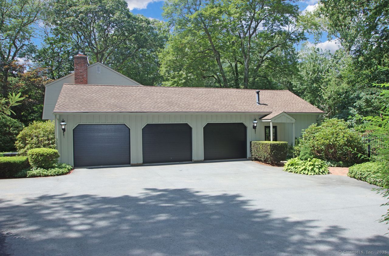 125 Wildcat Road Madison, CT 06443 - Photo 3 of 34 a front view of a house with yard and trees