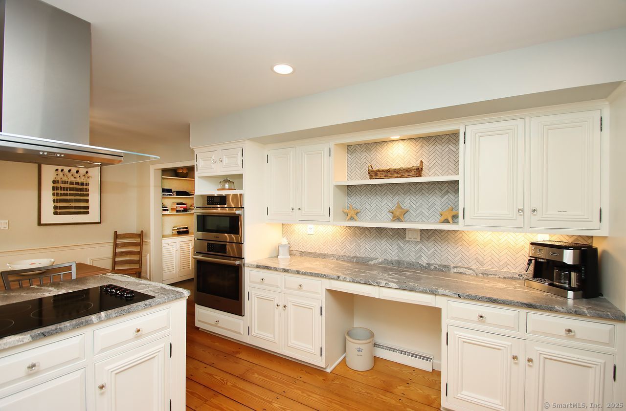 125 Wildcat Road Madison, CT 06443 - Photo 32 of 34 a kitchen with granite countertop a sink cabinets and stainless steel appliances