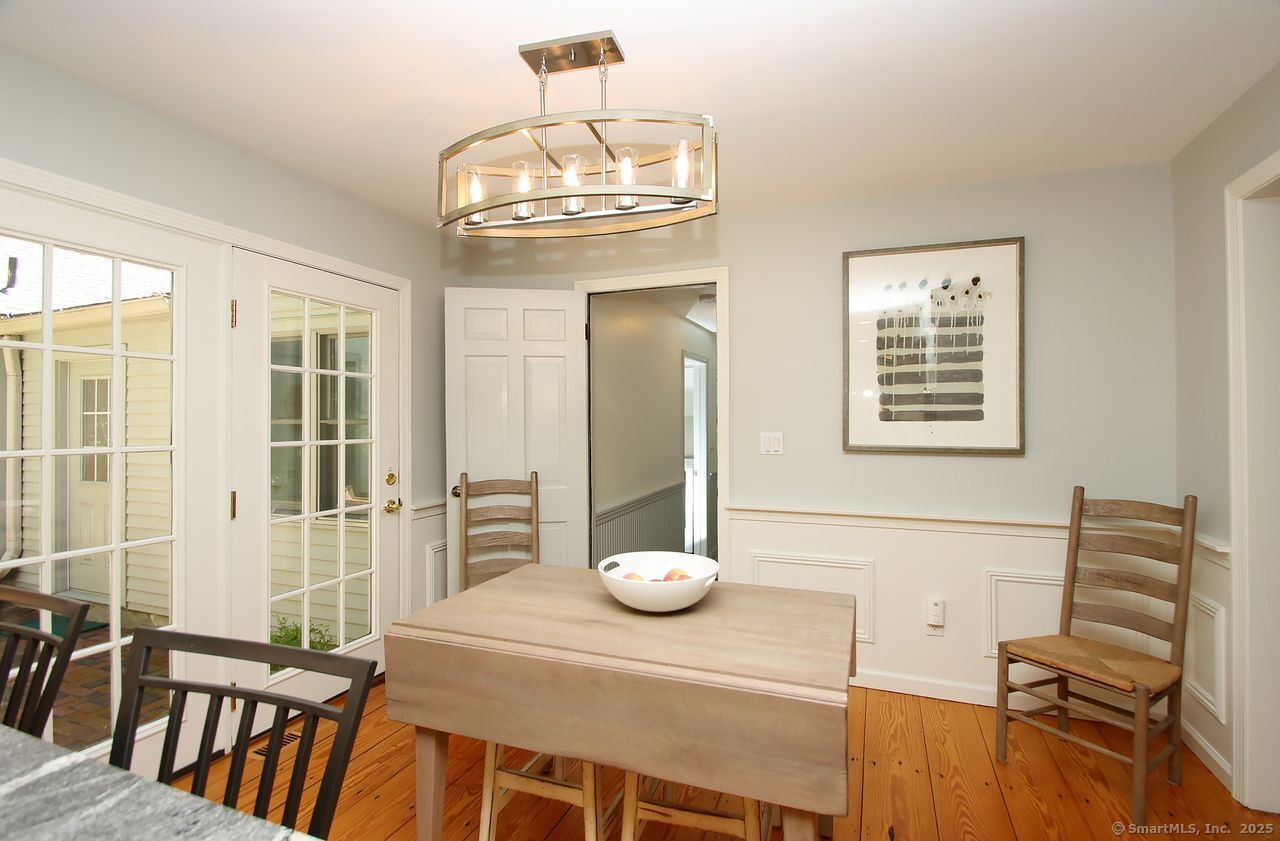 125 Wildcat Road Madison, CT 06443 - Photo 33 of 34 a view of a dining room with furniture and chandelier