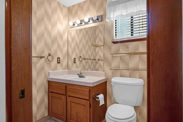 a white toilet sitting next to a window