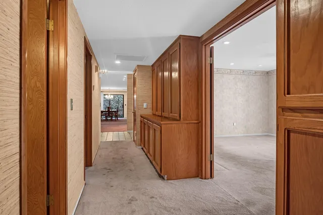 a bedroom with a large bed and a chandelier