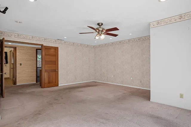 a view of empty room with ceiling fan