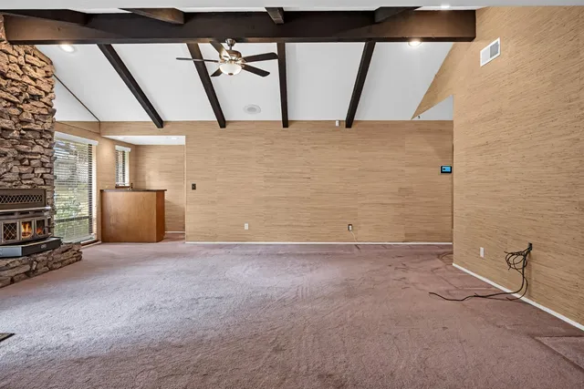 a view of an empty room with windows