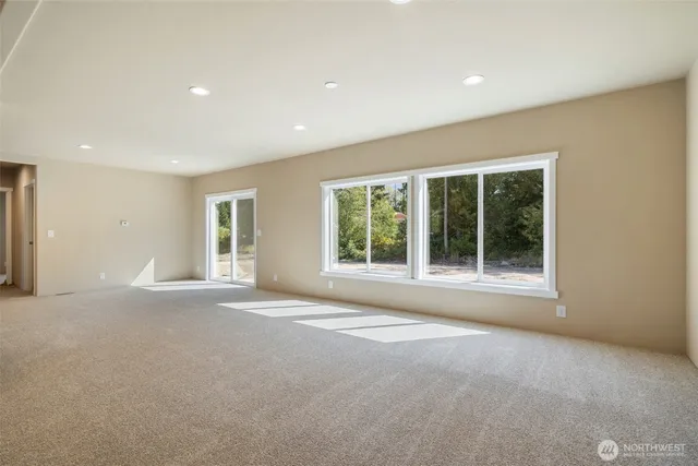 a view of a big room with windows and chandelier fan