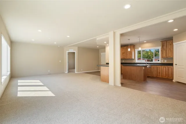 a view of an empty room with a kitchen